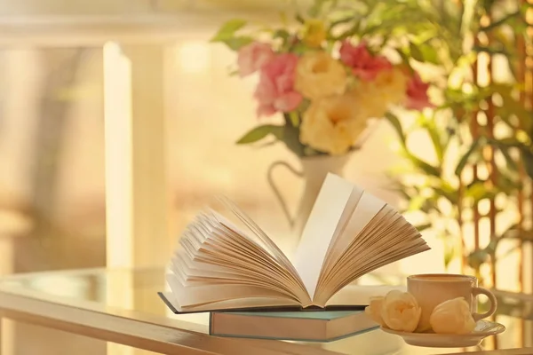 New books on table with cup — Stock Photo, Image