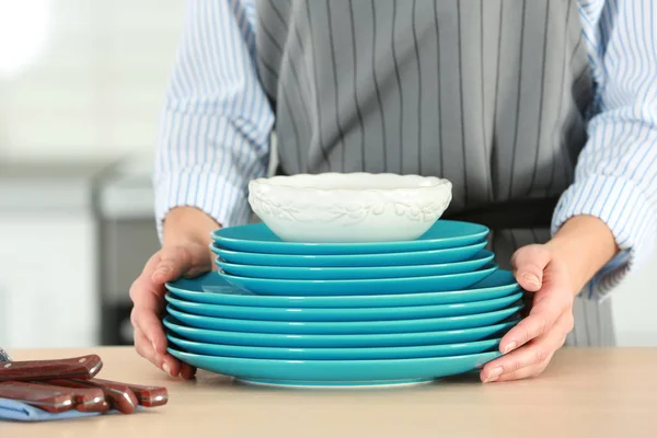 Female hands holding dishes — Stock Photo, Image