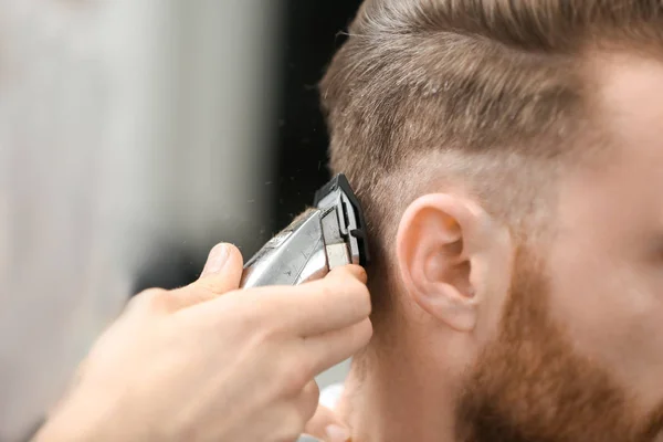 Barber making male hairstyle