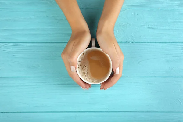 Mani femminili in possesso di tazza di caffè fresco — Foto Stock