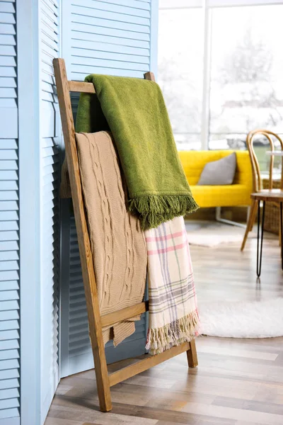 Plaids hanging on ladder — Stock Photo, Image