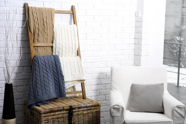 Knitted plaids hanging on ladder — Stock Photo, Image