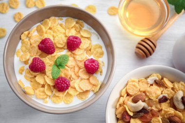 Tasty cornflakes with raspberries clipart