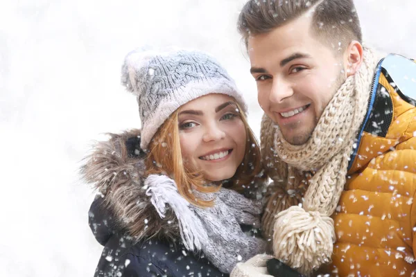 Young couple during snowfall — Stock Photo, Image