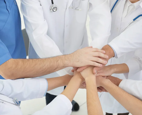 Doctors putting hands together — Stock Photo, Image