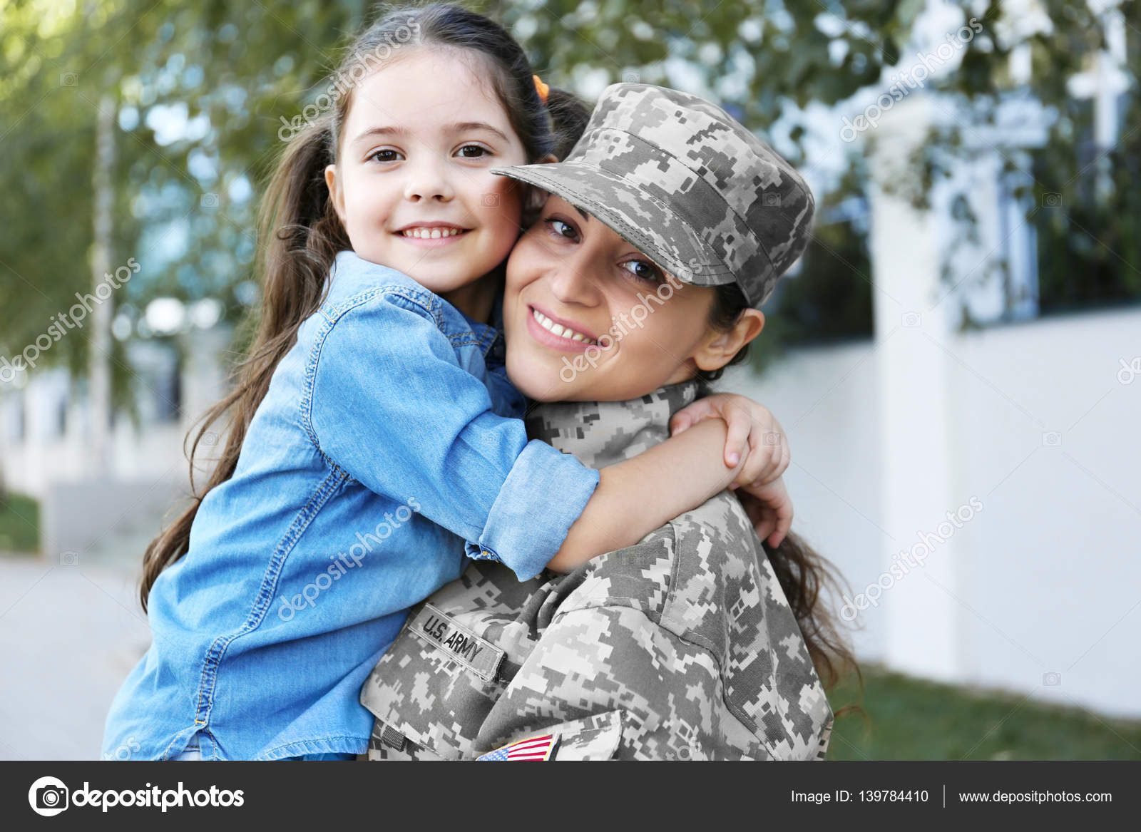 Mother in army uniform and daughter in the street Stock Photo by ...
