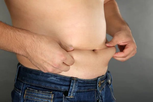 Man touching his fat belly — Stock Photo, Image