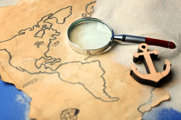 Magnifier and wooden anchor on old map — Stock Photo, Image