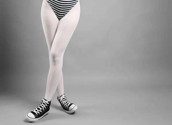 Woman in white tights and sneakers Stock Photo by ©belchonock