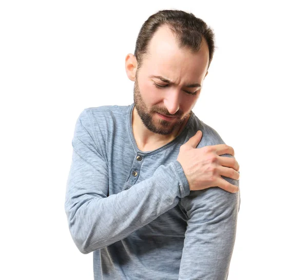 Handsome man suffering from pain in shoulder — Stock Photo, Image