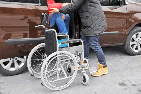 man helping handicapped man