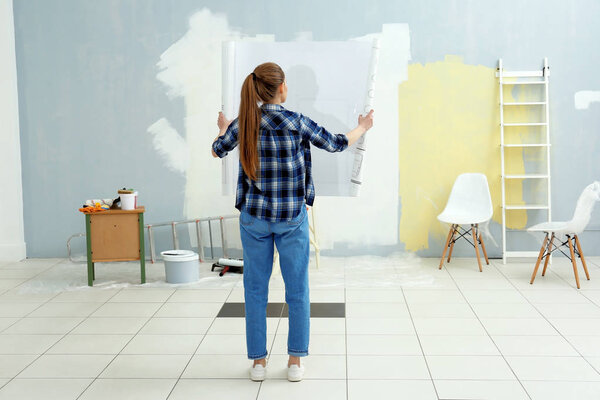 Young female decorator with drawing 