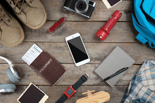 Outfit for travelling on wooden table — Stock Photo, Image