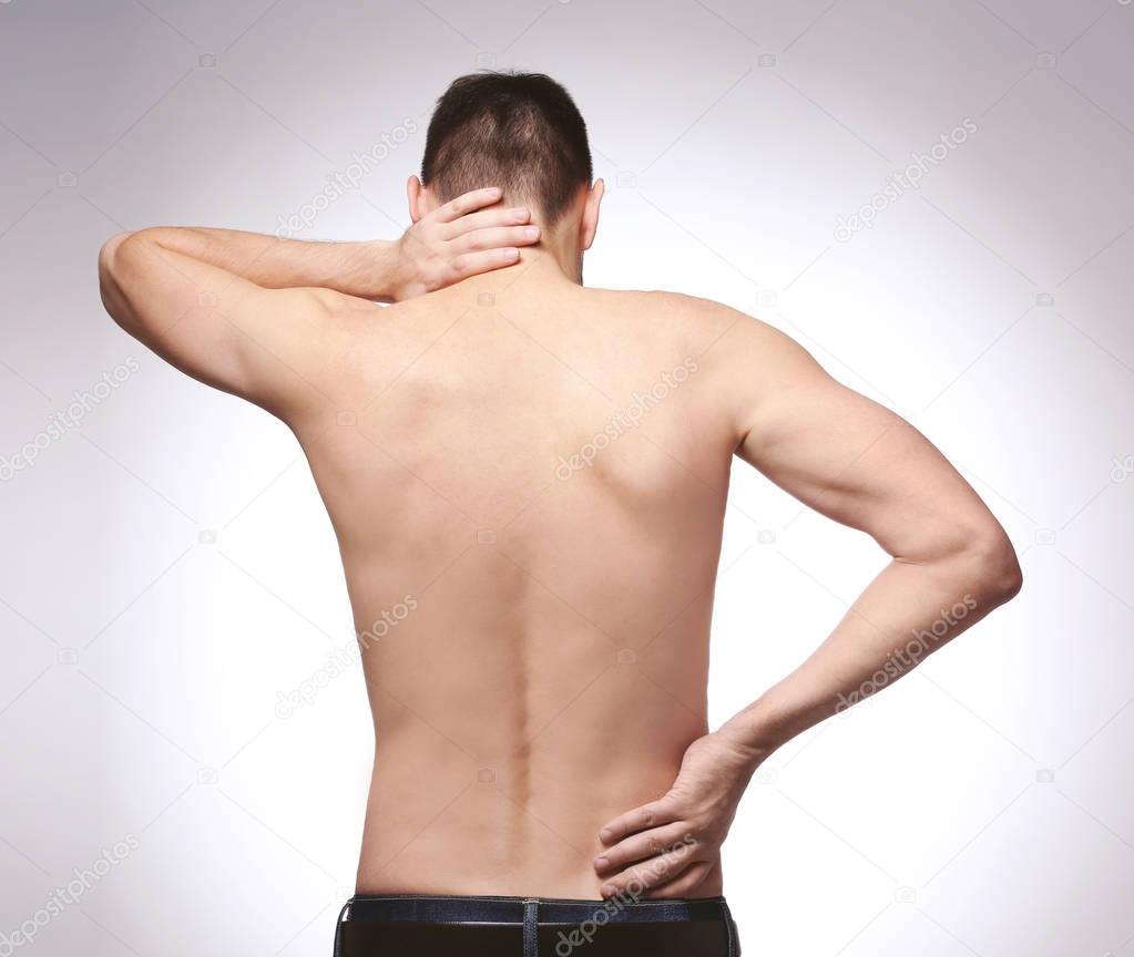 Young man with back pain  
