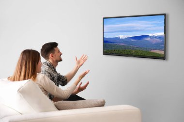 Evde televizyon izlerken aile. Boş zaman ve eğlence kavramı.