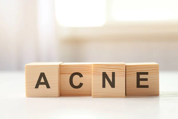 Word ACNE of wooden cubes — Stock Photo, Image