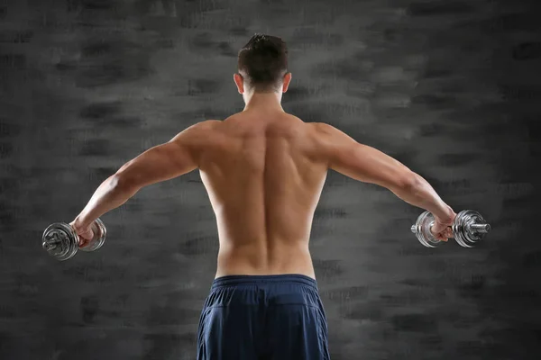 Sporty man doing exercises with dumbbells — Stock Photo, Image