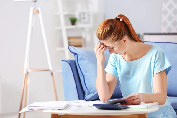 Young woman calculating taxes — Stock Photo, Image