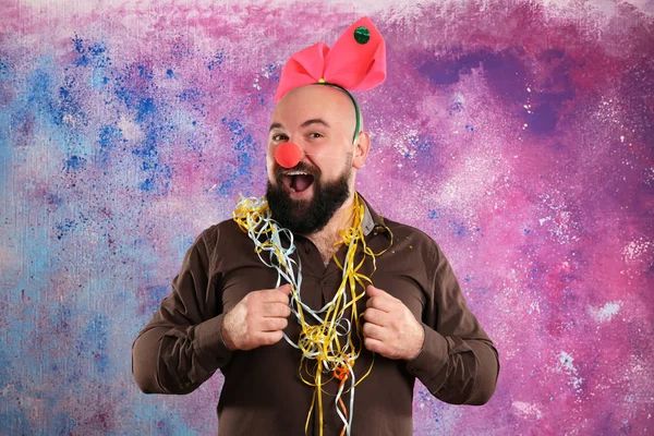 Funny fat man with party decor on color background — Stock Photo, Image