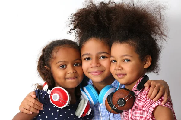 Three Cute African Girls Headphones Hugging White Background — Stock Photo, Image