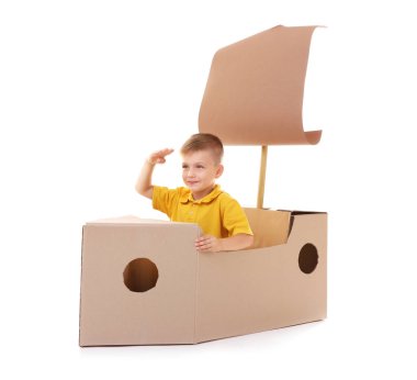 karton gemiyle birlikte oynayan çocuk  