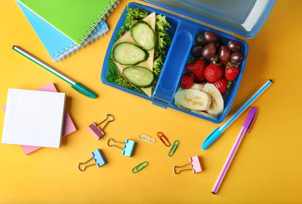 Tasty sandwich and fruits in lunchbox — Stock Photo, Image