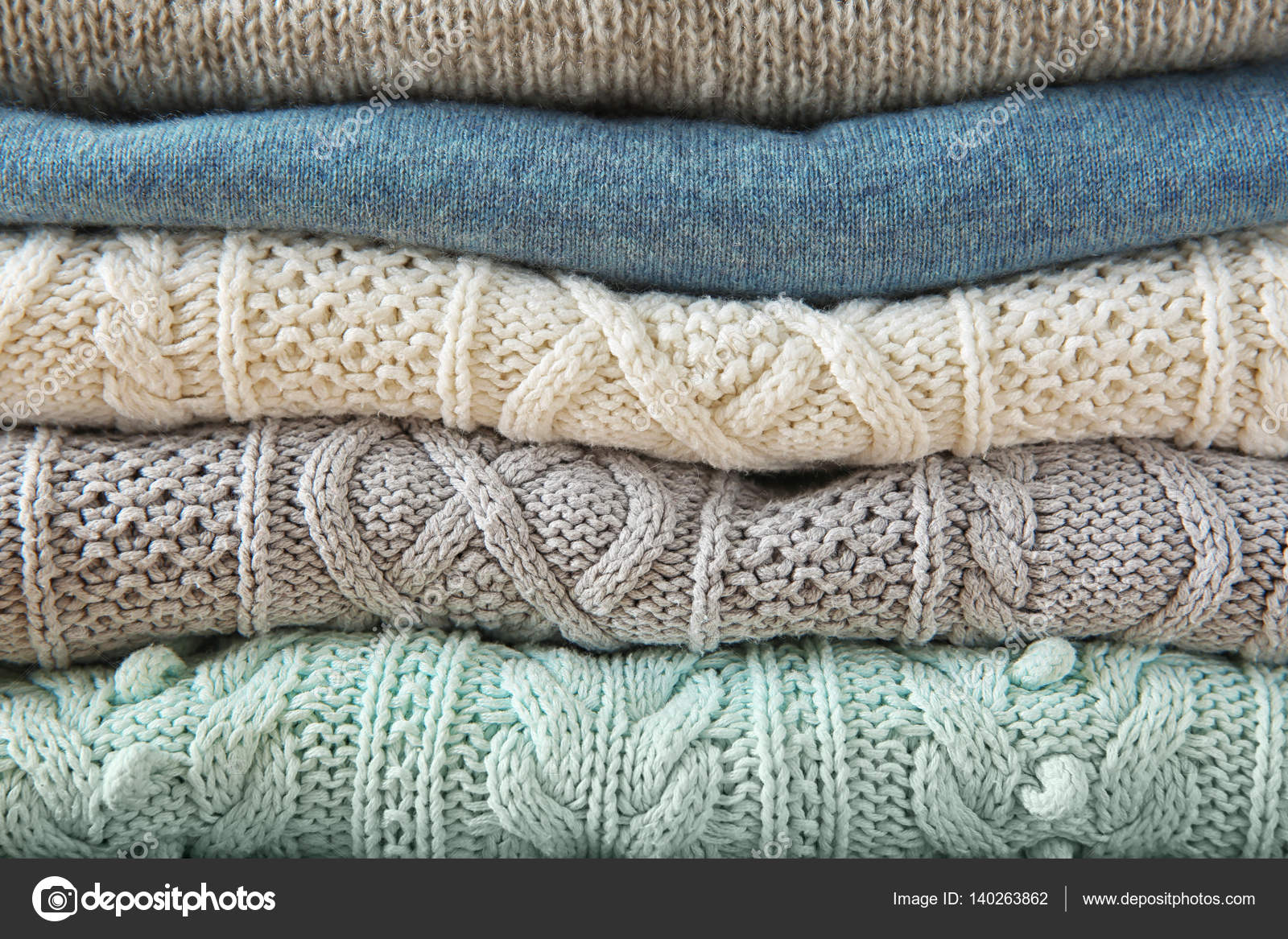 Stack of woolen clothes Stock Photo by ©belchonock 140263862