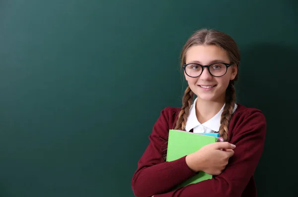 Girl near green school blackboard — Stock Photo, Image
