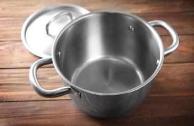 Ahşap masa üzerinde paslanmaz tencere