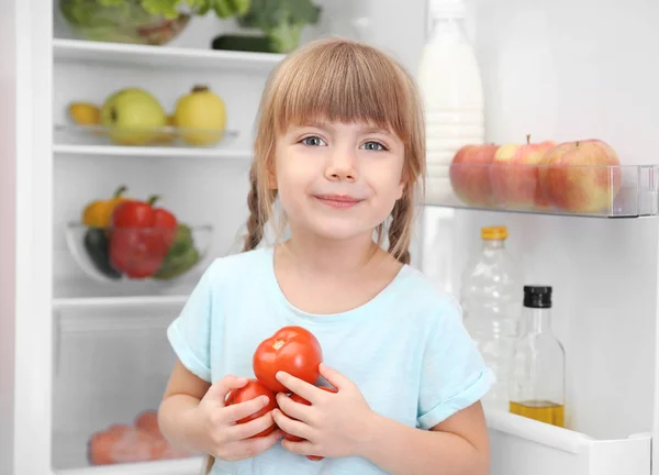 Small girl with tomatoes — Stock Photo, Image