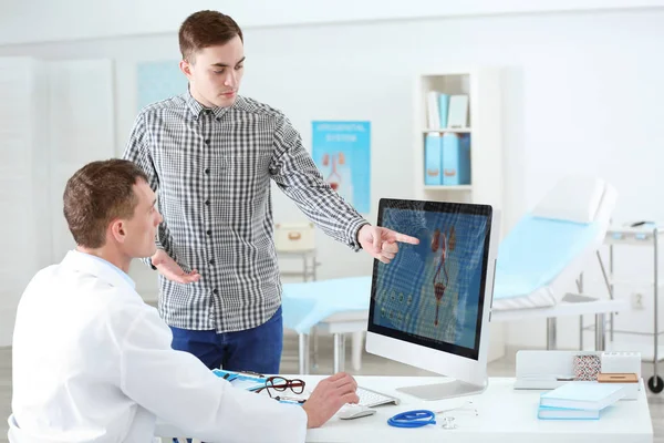 Medical concept. Doctor showing results of urology diagnostic on computer monitor — Stock Photo, Image