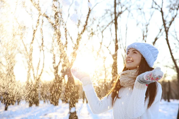 Beautiful young woman playing with snow — Stock Photo, Image