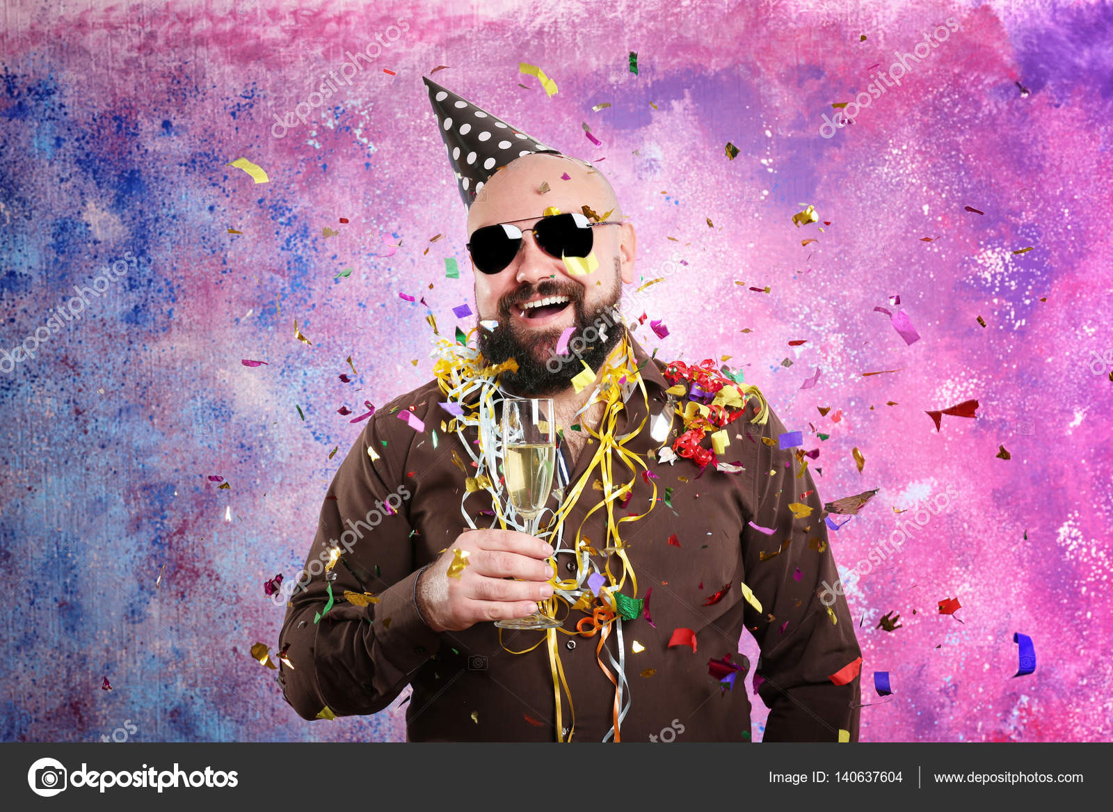 Funny fat man with party hat and glass of champagne on color