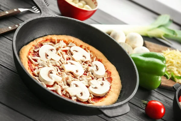 Unbaked pizza in pan