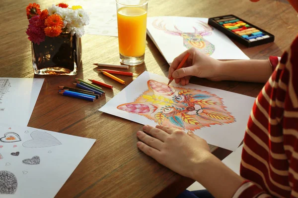 Young woman coloring pictures