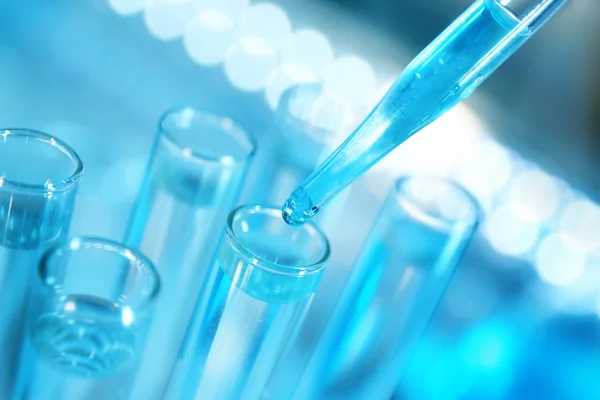 Pipette with laboratory flasks — Stock Photo, Image