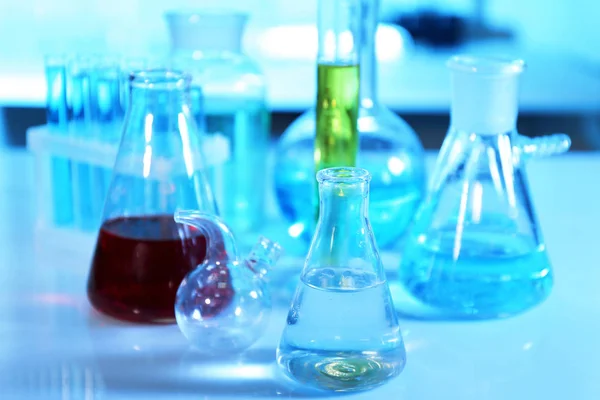 Transparent laboratory flasks with liquid — Stock Photo, Image