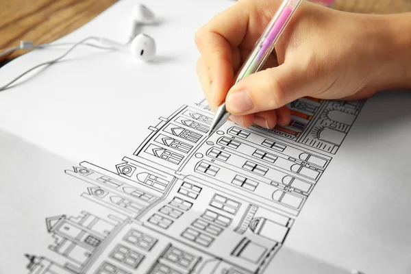 Woman drawing in coloring book — Stock Photo, Image