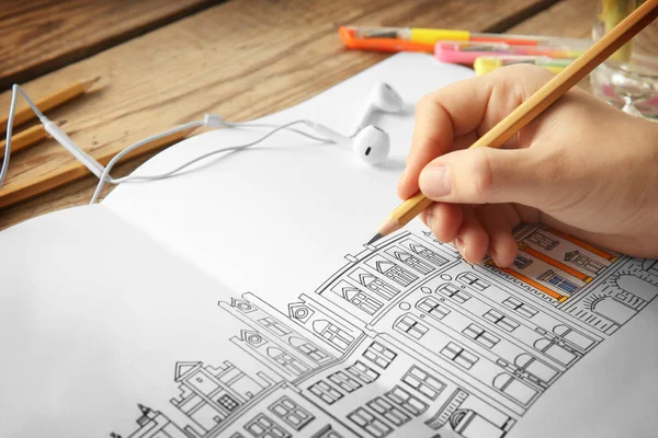 Woman drawing in coloring book — Stock Photo, Image