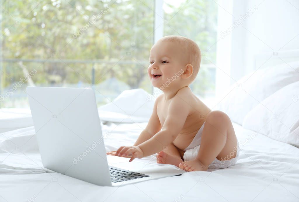 Cute baby boy with laptop