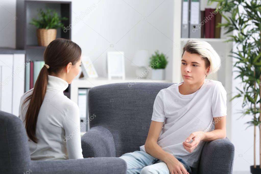 psychologist working with teenager boy 