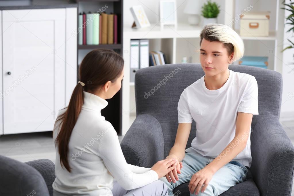 psychologist working with teenager boy 