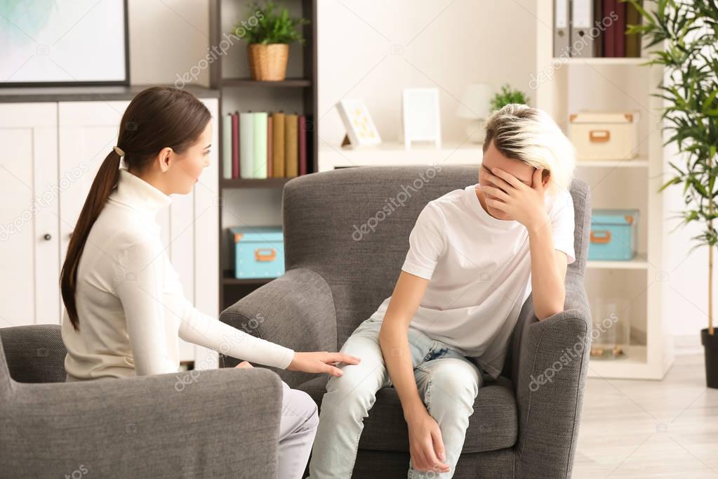 psychologist working with teenager boy 