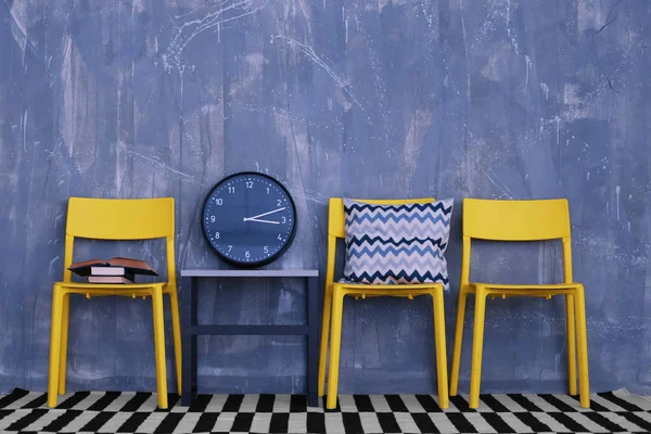 modern chairs against blue wall