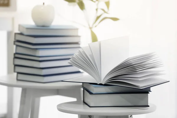 Piles of books on tables — Stock Photo, Image