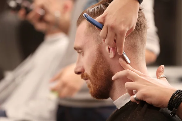 Barber making modern hairstyle