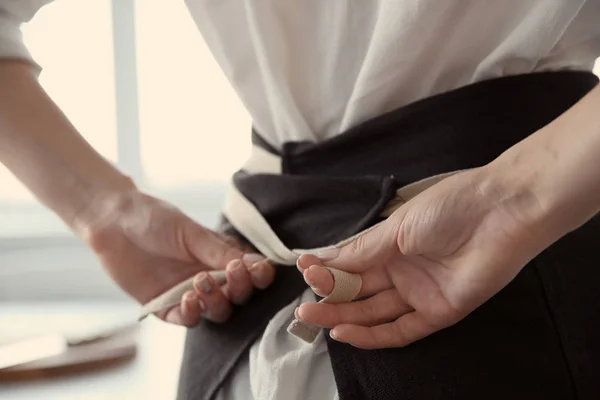 Woman tying up her apron