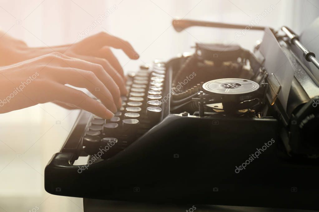 hands typing on typewriter