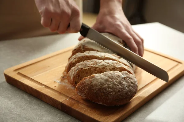 Manos cortar pan casero — Foto de Stock