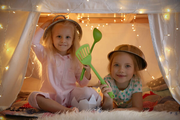 little girls playing with kitchenware